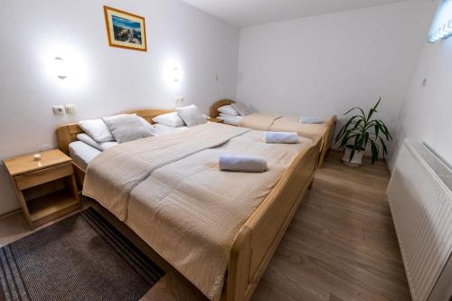 a bedroom with a large bed with two pillows on it at Zimzeleni Apartments in Zreče