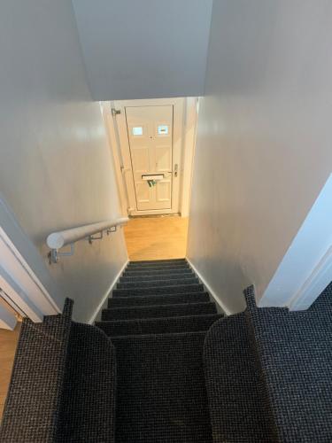 a stairway leading to a room with a door at M&B Accommodation in Lincoln