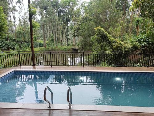 una piscina con pinzas en el medio en Cozy 3 BHK PoolVilla near Nagerhole National park., en Wayanad