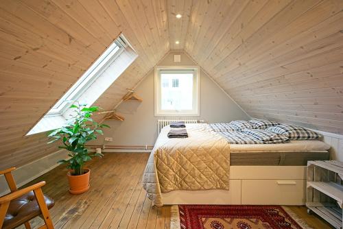 a bedroom with a bed in a attic at Eklinds Rum och Trädgård in Gothenburg