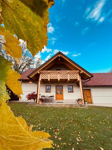 a large white house with orange doors on a yard at Villa VINEYARD in Velika Nedelja