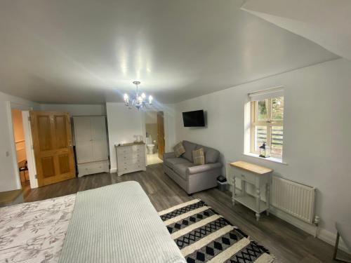 a living room with a couch and a chair at Rostrevor Valley 6-Br Sleeps 20 w Hot Tub & View in Newry