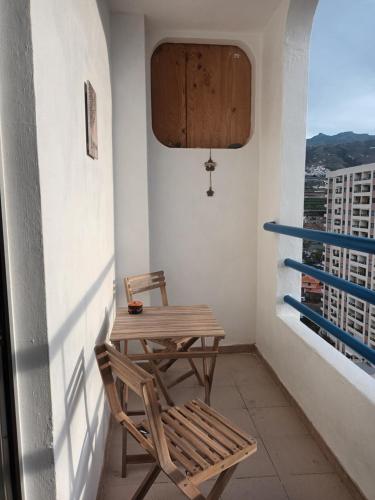 a table and chair on a balcony with a view at Cosy Studio on rooftop Playa Paraiso in Playa Paraiso