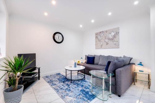 a living room with a couch and a table at 3 Bedroom House with Parking in Windsor - Family and Contractor friendly in Windsor