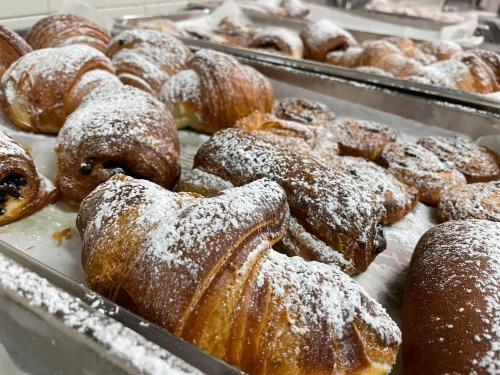 a tray of donuts with powdered sugar on them at Hotel Casa Valdese Roma in Rome