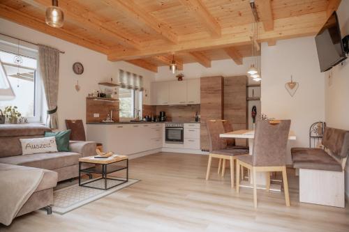 a kitchen and living room with a couch and a table at Meine Auszeit – das ferienhaus in Sankt Georgen am Reith