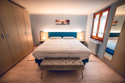 una camera con un grande letto e due finestre di Appartamento - Borgo55 - Centro Paese a Bosco Chiesanuova