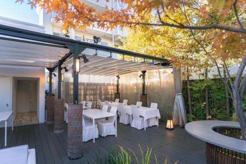 a patio with white tables and white chairs at Y11 azabu hotel by Mrt in Tokyo