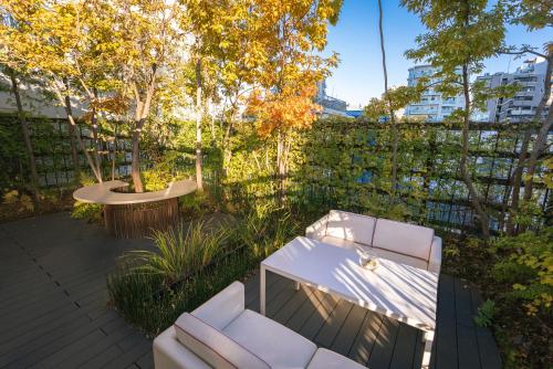 a patio with two white chairs and a table at Y11 azabu hotel by Mrt in Tokyo