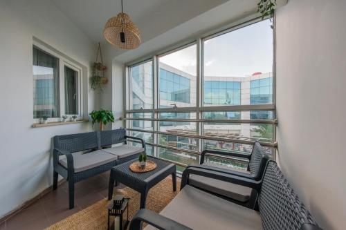 a living room with chairs and tables and a large window at Expo Park Hotel in Antalya