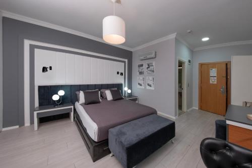 a bedroom with a bed and a desk and a chair at Expo Park Hotel in Antalya