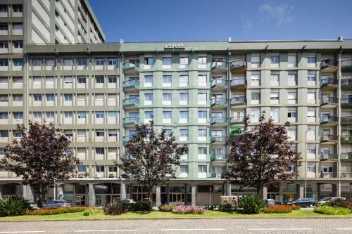 an apartment building with trees in front of it at Acta The Clover in Porto