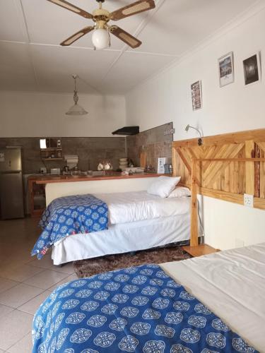 a bedroom with two beds and a kitchen at Scholtz Self-catering Accommodation in Lüderitz