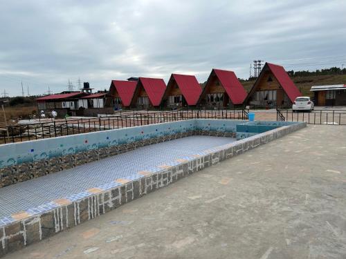 a swimming pool with a row of red roofs at SYLWAN-O SUNRISE HOMESTAY 