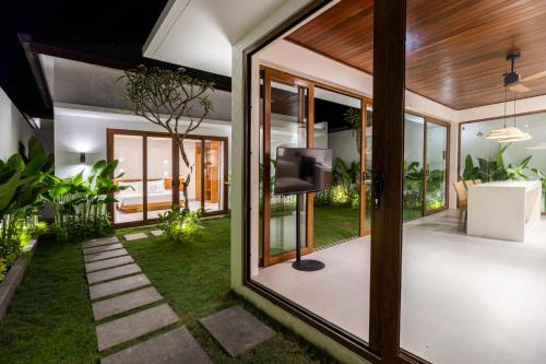 a living room with a television in a house at J4 Villas Sanur in Sanur