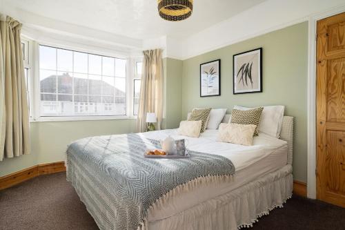 a bedroom with a large bed and a window at House in Windsor hosted by Nicola in Windsor