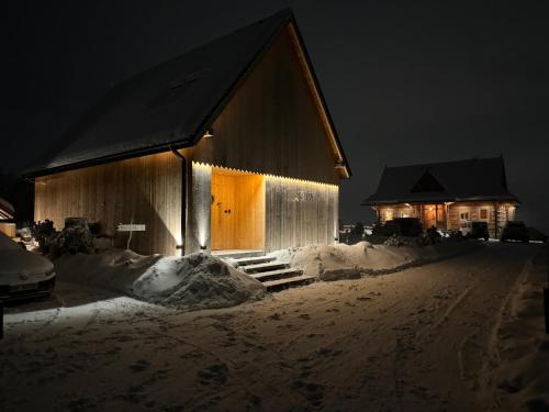 a building covered in snow at night at SOPA Zakopane in Zakopane