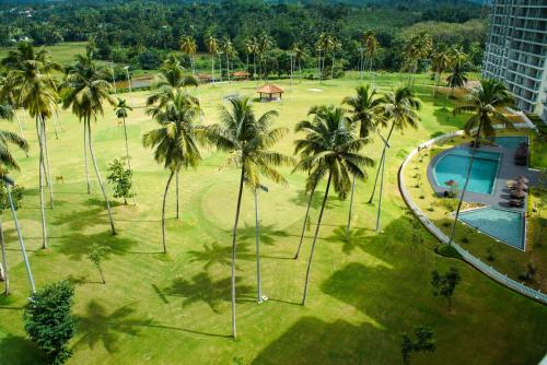 an aerial view of a park with palm trees and a swimming pool at Golfers' Paradise Kahathuduwa in Gonapola