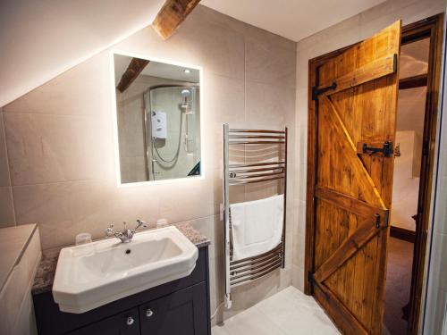 a bathroom with a sink and a wooden door at 1 bed in Bishops Frome 75600 in Bishops Frome