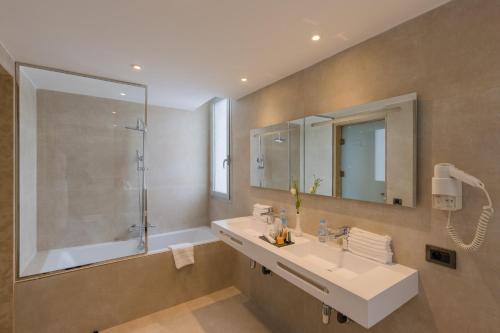 a bathroom with a sink and a shower and a mirror at Kenzi Solazur in Tangier