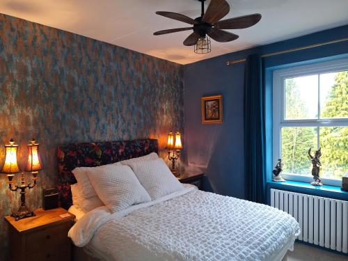 a bedroom with a bed and a ceiling fan at Park House Matlock in Matlock