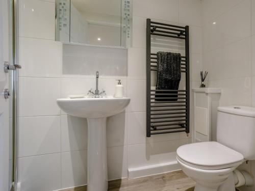 a white bathroom with a toilet and a sink at 1 bed in Paignton 78200 in Paignton