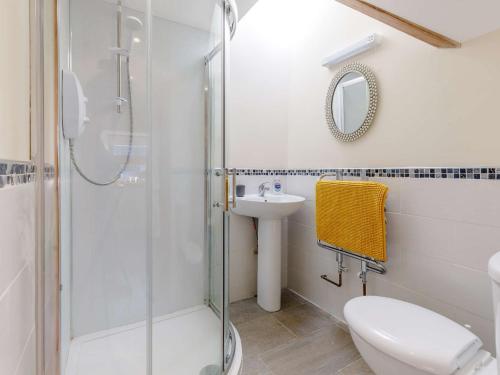 a bathroom with a shower and a toilet and a sink at 1 Bed in Hay-on-Wye 81465 in Painscastle
