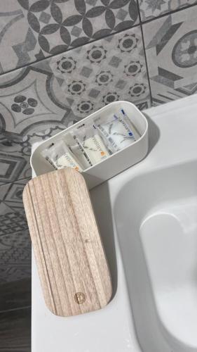 a container of toothbrushes sitting on top of a toilet at ALMA B&B Cosenza CENTRO in Cosenza
