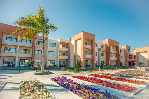 a courtyard with flowers in front of a building at Helnan Hotel - Port Fouad in Port Said