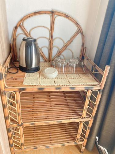 a table with a tea kettle and glasses on it at 2 Vikings Guesthouse in Karon Beach
