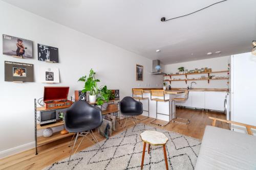 a living room with a table and chairs and a desk at Beautifully renovated 1BR Flat in Walthamstow in London