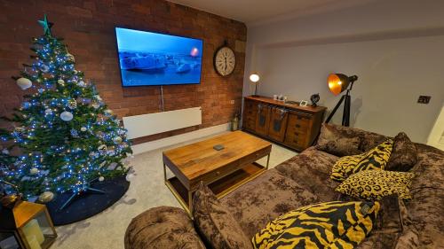 a living room with a christmas tree and a couch at Staycation York at Cocoa Suites in York