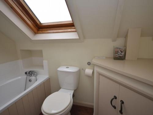 a bathroom with a white toilet and a skylight at 2 bed property in South Allington FERN3 in South Pool