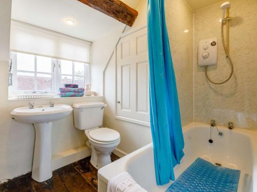 a bathroom with a toilet and a sink and a tub at 1 Bed in Cleobury Mortimer 82957 in Cleobury Mortimer