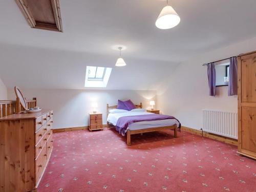 a bedroom with a bed and a red carpet at 3 Bed in Threlkeld SZ083 in Threlkeld