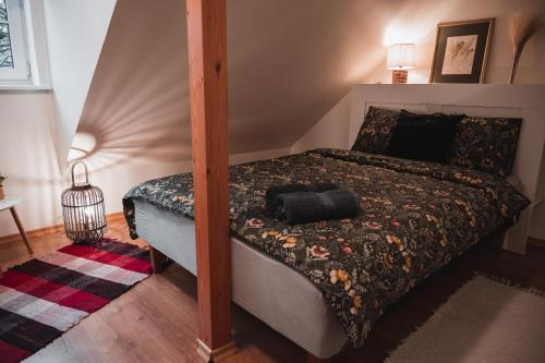 a bedroom with a bed with a wooden post at Viljandi Jahiloss in Viljandi