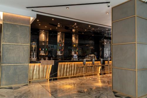 a bar with stools in a restaurant at W Dubai - The Palm in Dubai
