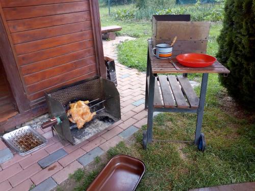 a grill with a chicken cooking on top at Apartmán " Matej" in Smrečany