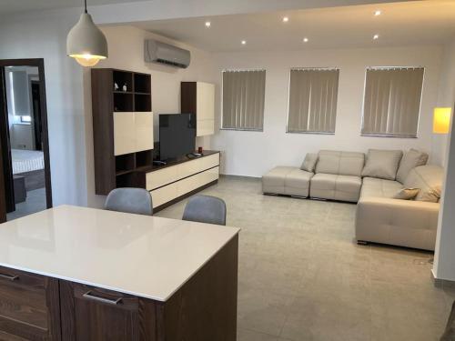 a large living room with a couch and a table at Elegant Maisonette in Malta by AssetFlow PRO in Marsaskala