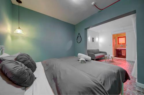 a bedroom with a large bed and a living room at Boho Rooms Sliema in Sliema
