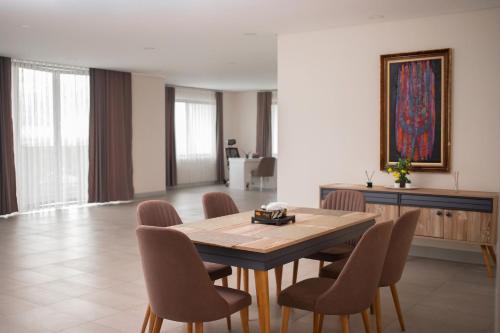 ein Esszimmer mit einem Holztisch und Stühlen in der Unterkunft Luxurious Penthouse With Luxurious Pool in Takoradi