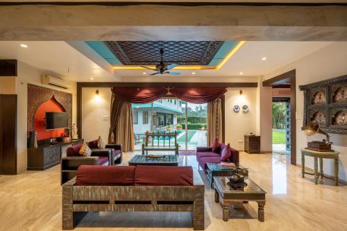 a living room with a couch and a table at Karhan 3BHK Luxury Villa In Lonavala in Lonavala