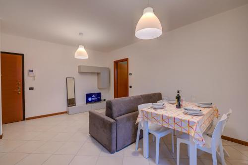 a living room with a table and a couch at Magnolia - Happy Rentals in Laveno-Mombello