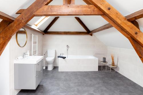 an attic bathroom with a white tub and a toilet at Villa La Mer - 600m de la plage Mesnil Val in Criel-sur-Mer