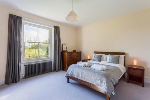 a bedroom with a bed and a large window at The Old Rectory in Bristol
