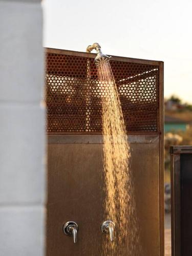 a stream of water coming out of a metal door at Neutra Home Joshua Tree Luxury Retreat Pool and Spa in Joshua Tree