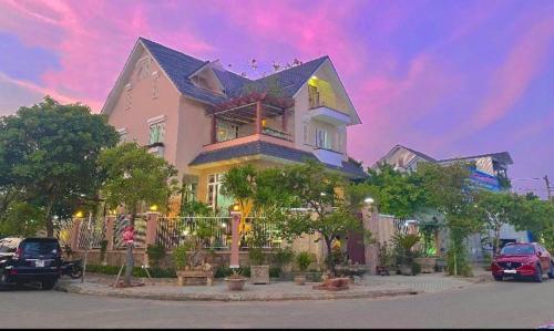 a large house with cars parked in front of it at Ngọc Phương Anh Homestay Huế in Hue