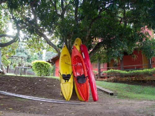 three kayaks are lined up next to a house at Pousada da Pedra Rifaina in Rifaina