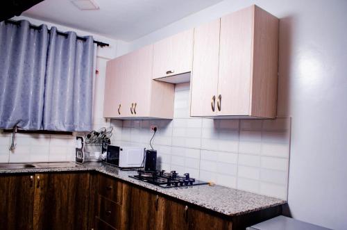 a kitchen with white cabinets and a counter top at Buvan homes in Eldoret