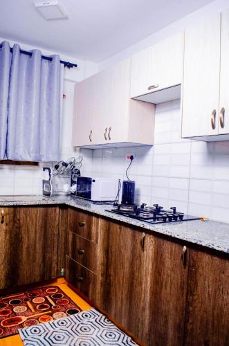a kitchen with wooden counter tops and white cabinets at Buvan homes in Eldoret